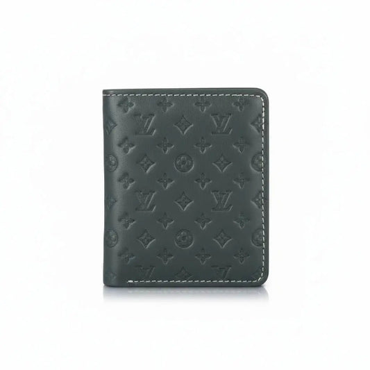 Green leather wallet with monogram pattern on a white background