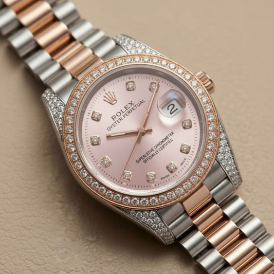 Rolex Datejust wristwatch with a two-tone rose gold and stainless steel Oyster Perpetual bracelet, a pink dial, and a diamond-set bezel on a beige textured background.