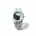 White marble-patterned watch on a stand with a blurred background
