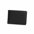 Black leather wallet held by a gloved hand on a wooden surface